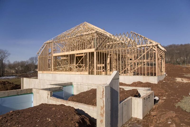 A custom home under construction with timber framing