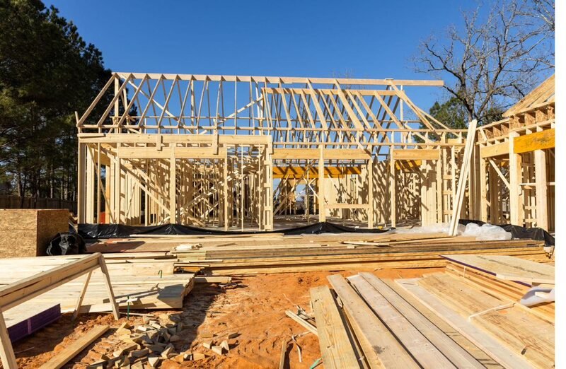 A custom home under construction with wood framing