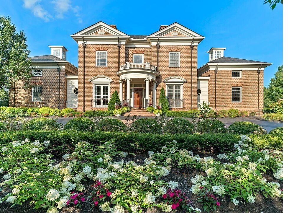 A grand brick colonial custom home with landscaped grounds in New Jersey