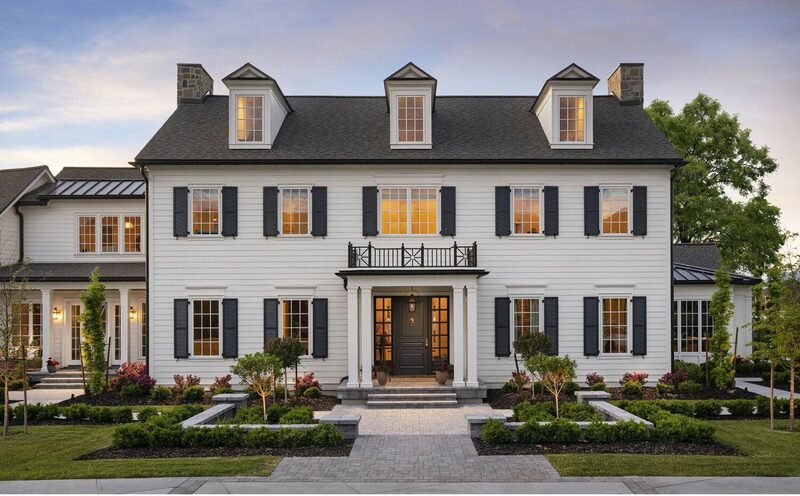 A cream colonial custom home in New Jersey at dusk
