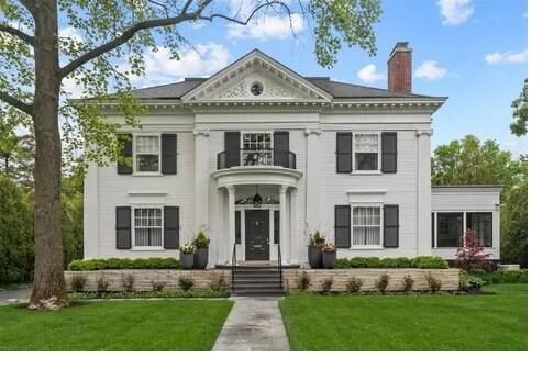 White Greek revival colonial home with columns and pediment