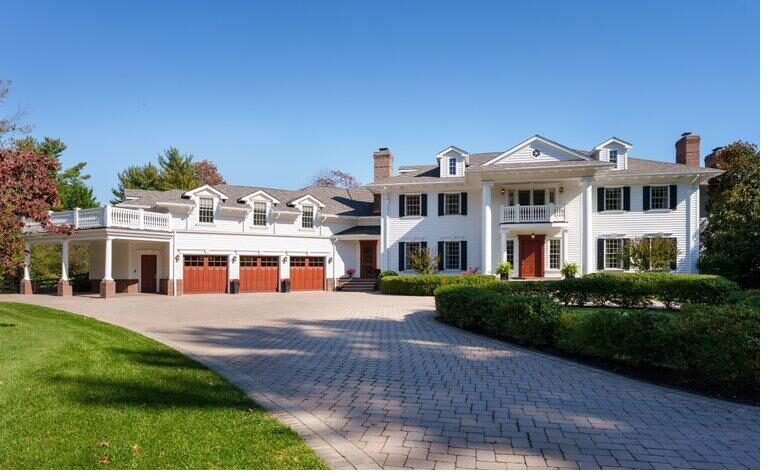 White colonial custom home built on a landscaped lot in New Jersey