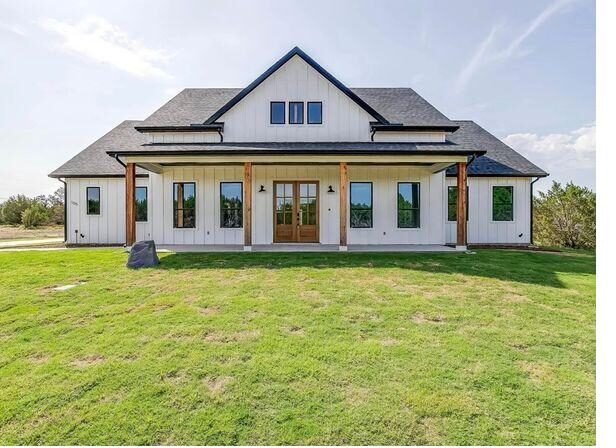 White modern farmhouse custom home with board and batten siding